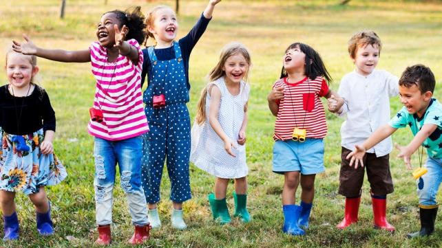 A group of children standing in a line Description automatically generated with low confidence