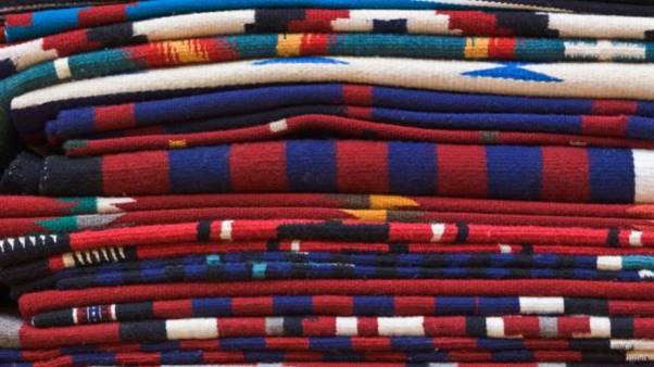 A stack of blankets in different colors  AI-generated content may be incorrect.
