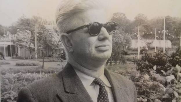 A person wearing sunglasses and a suit  AI-generated content may be incorrect.