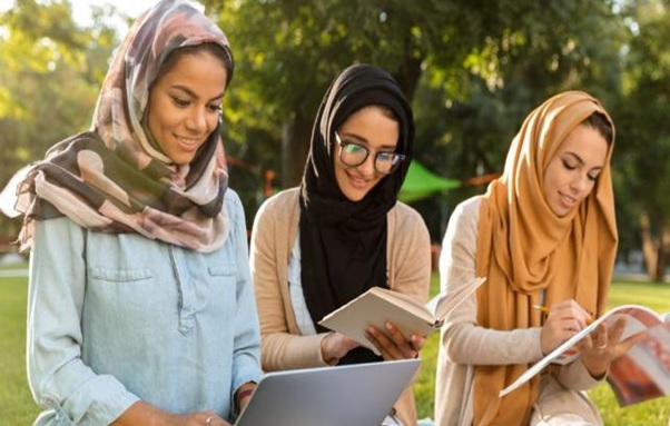 A group of women sitting outside  AI-generated content may be incorrect.