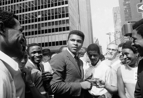 Muhammad Ali is surrounded by autograph seekers in Manhattan in 1968.