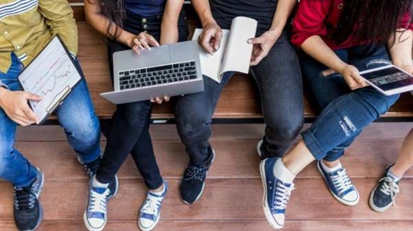 A group of people sitting on a bench  AI-generated content may be incorrect.