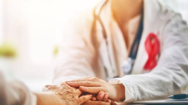 A doctor holding a patient's hand  AI-generated content may be incorrect.