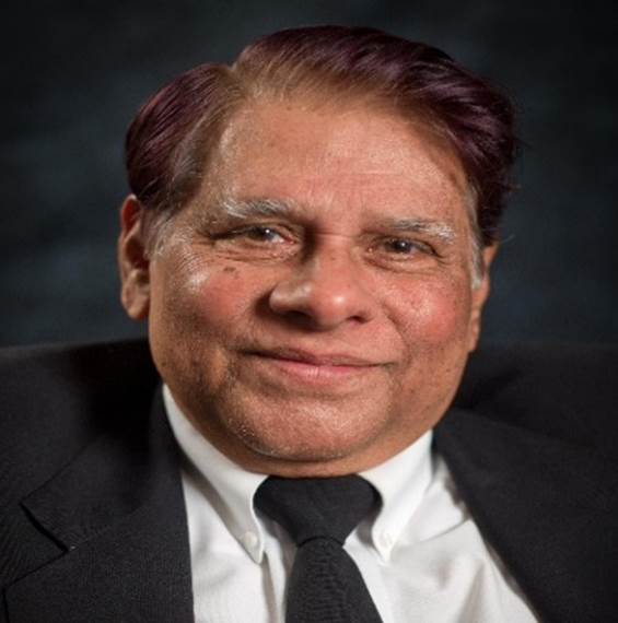 A person in a suit and tie Description automatically generated with medium confidence