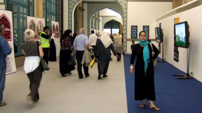A group of people in a hallway Description automatically generated with medium confidence