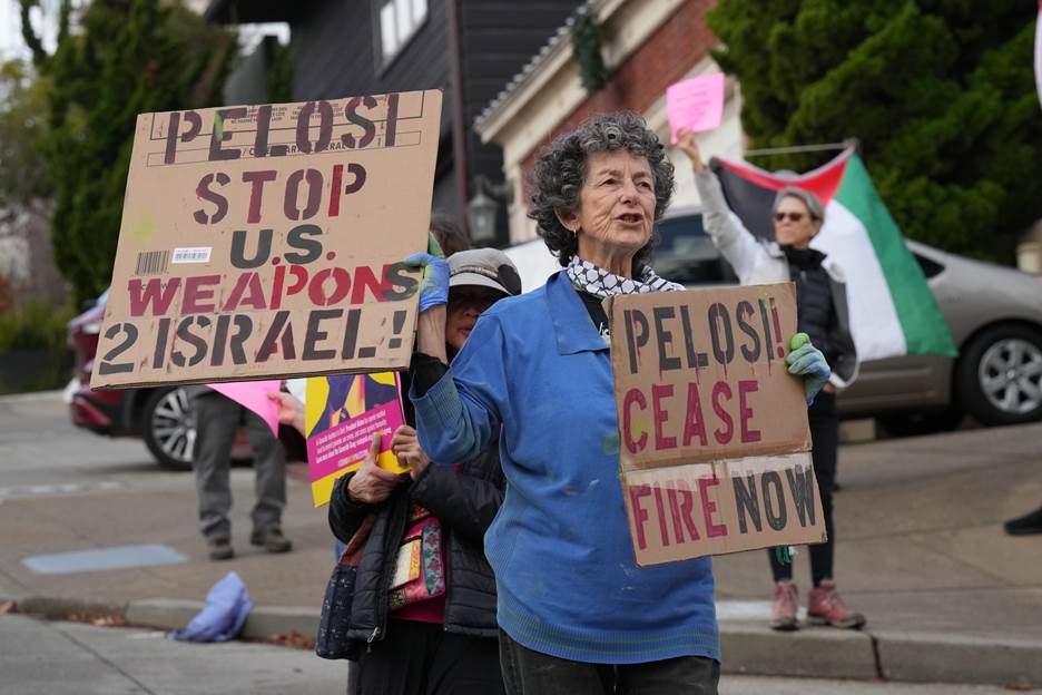 A group of people holding signs Description automatically generated