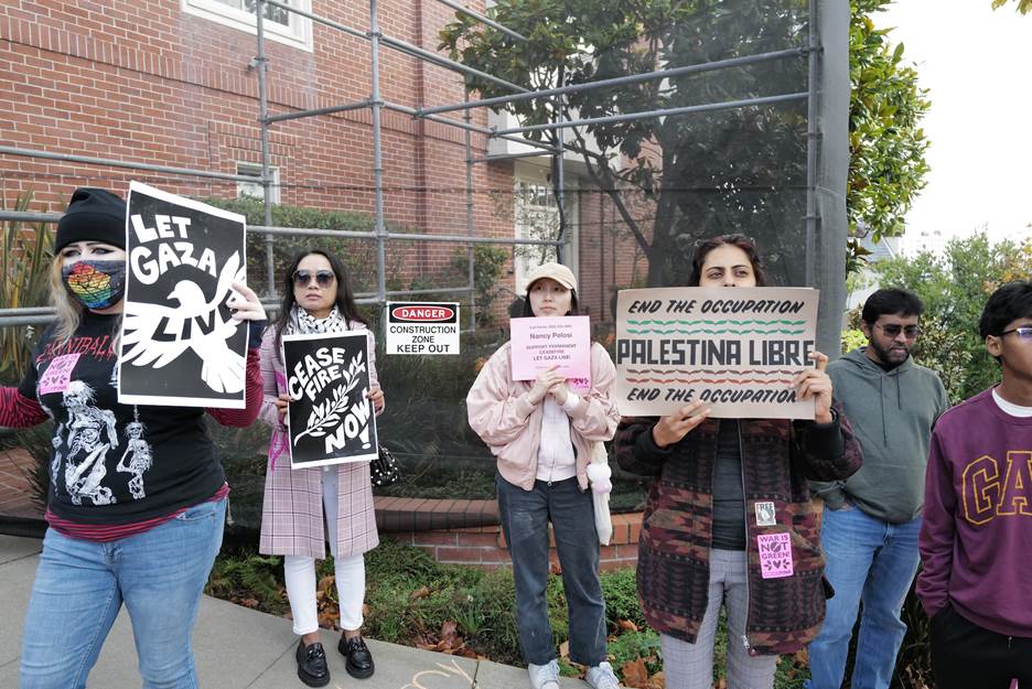 A group of people holding signs Description automatically generated