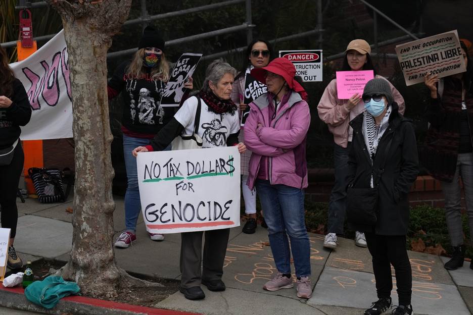 A group of people holding signs Description automatically generated