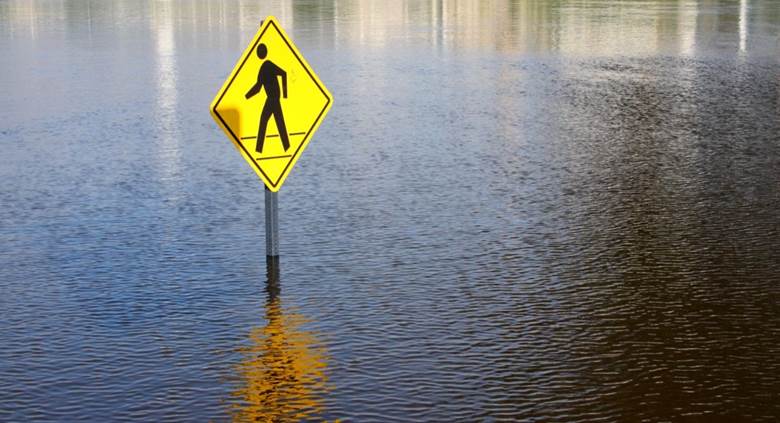 A yellow sign in water Description automatically generated