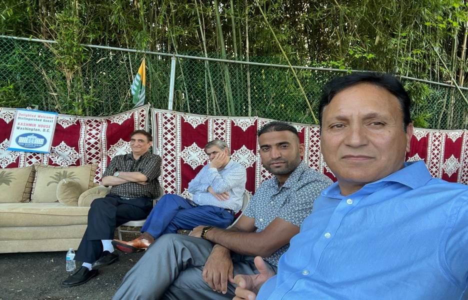 A group of men sitting on a bench Description automatically generated with medium confidence
