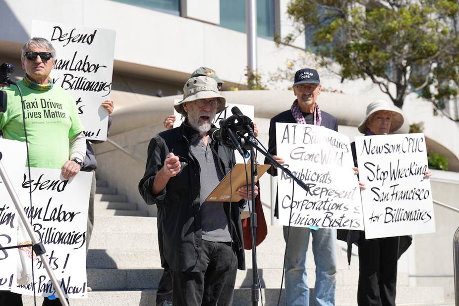 A group of people holding signs Description automatically generated