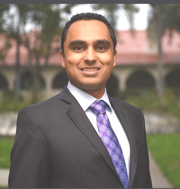 A person in a suit and tie Description automatically generated with medium confidence