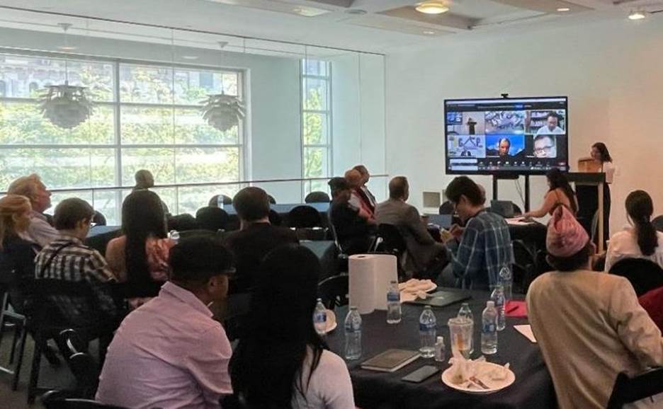 A group of people sitting at a table Description automatically generated