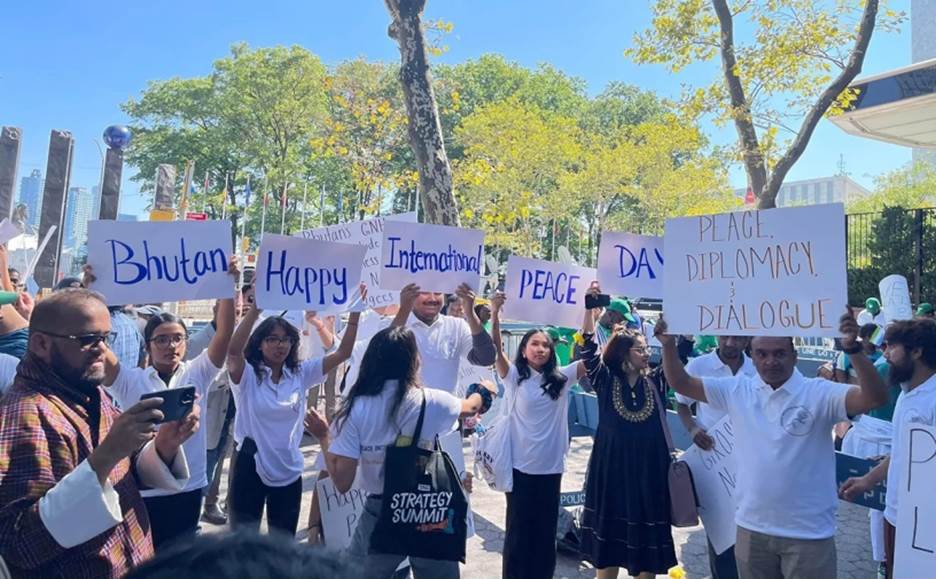 A group of people holding signs Description automatically generated