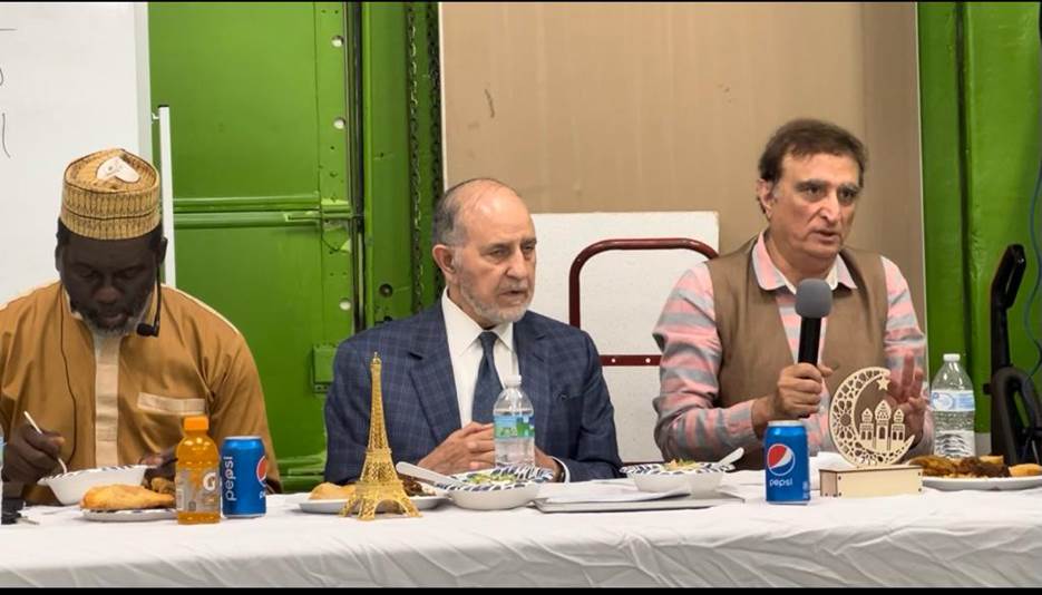 A group of men sitting at a table Description automatically generated