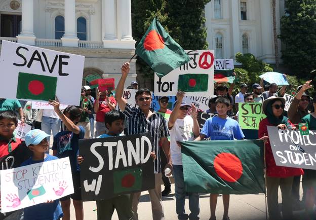 A group of people holding signs Description automatically generated