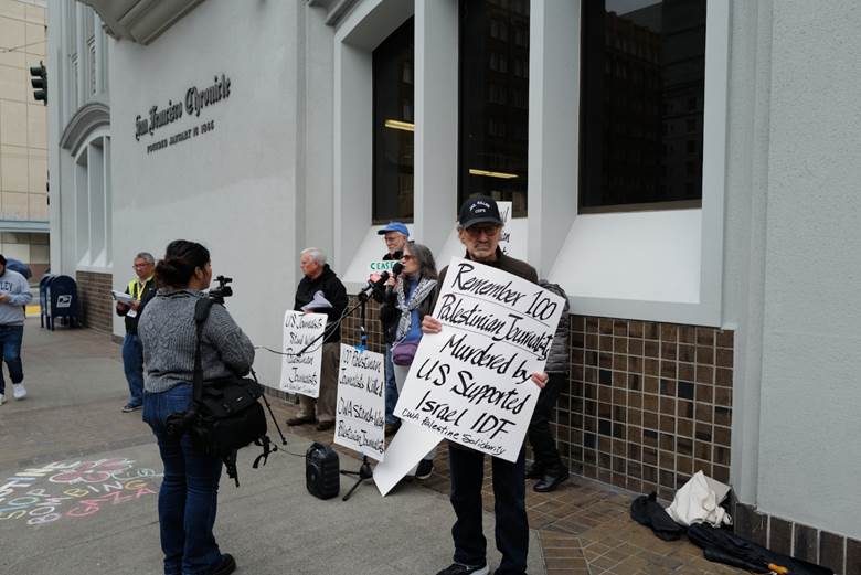 A group of people holding signs Description automatically generated