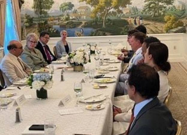 A group of people sitting at a table Description automatically generated