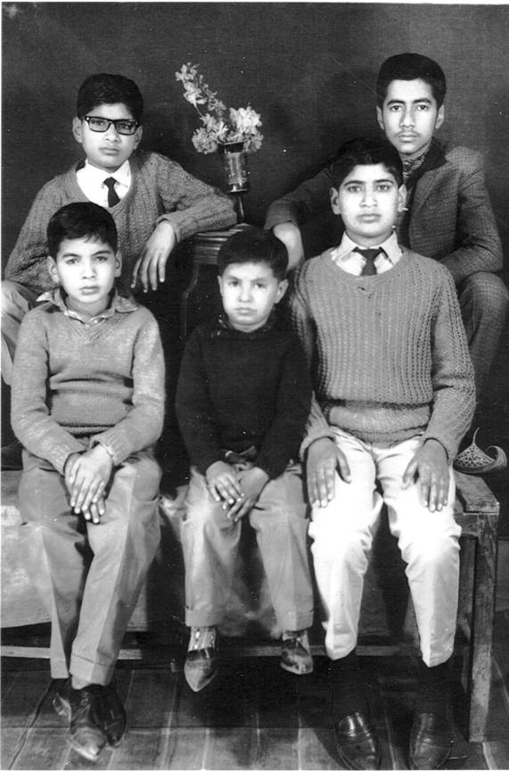 A group of boys sitting together Description automatically generated