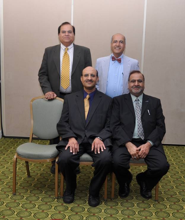 A group of men sitting in chairs Description automatically generated