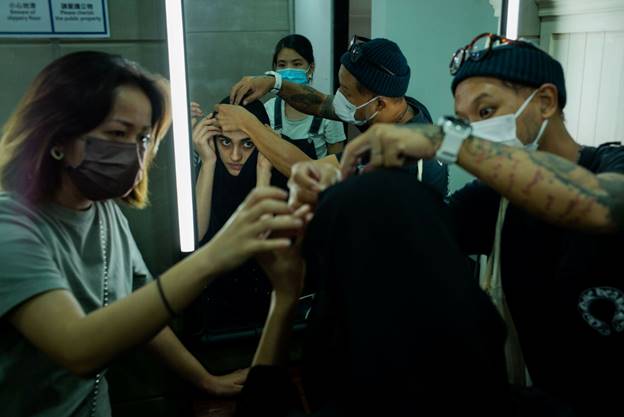 A group of people wearing masks  Description automatically generated