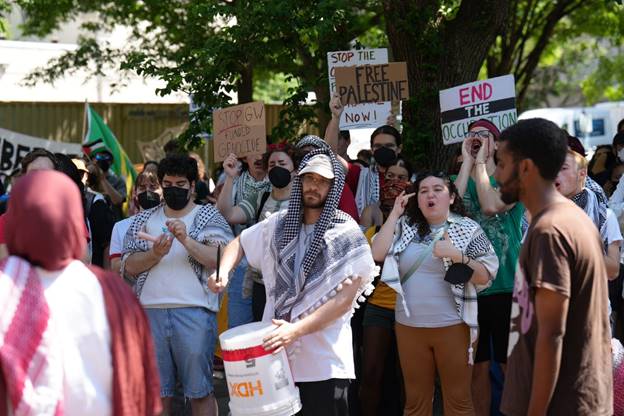 A group of people protesting Description automatically generated
