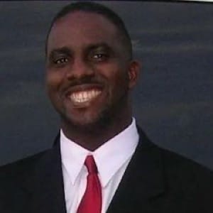 A person in a suit and tie Description automatically generated