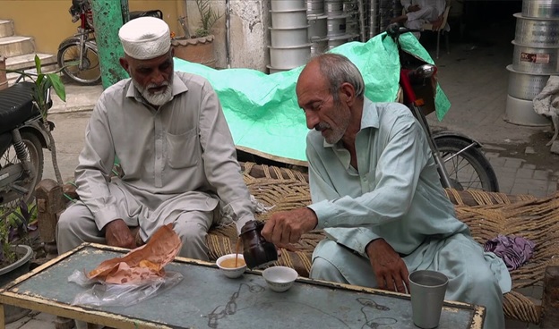 A person pouring a drink into a cup  AI-generated content may be incorrect.