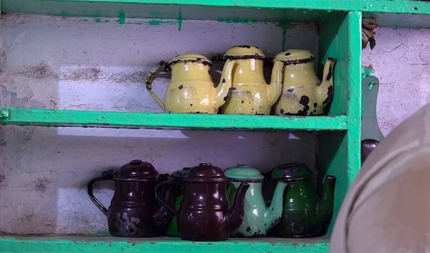 A group of teapots on a shelf  AI-generated content may be incorrect.
