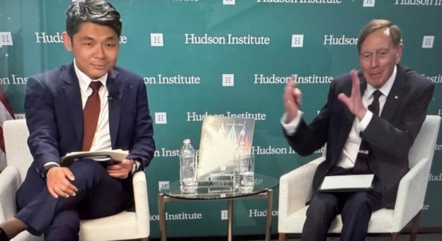 A person in a suit sitting next to a person in a suit  AI-generated content may be incorrect.