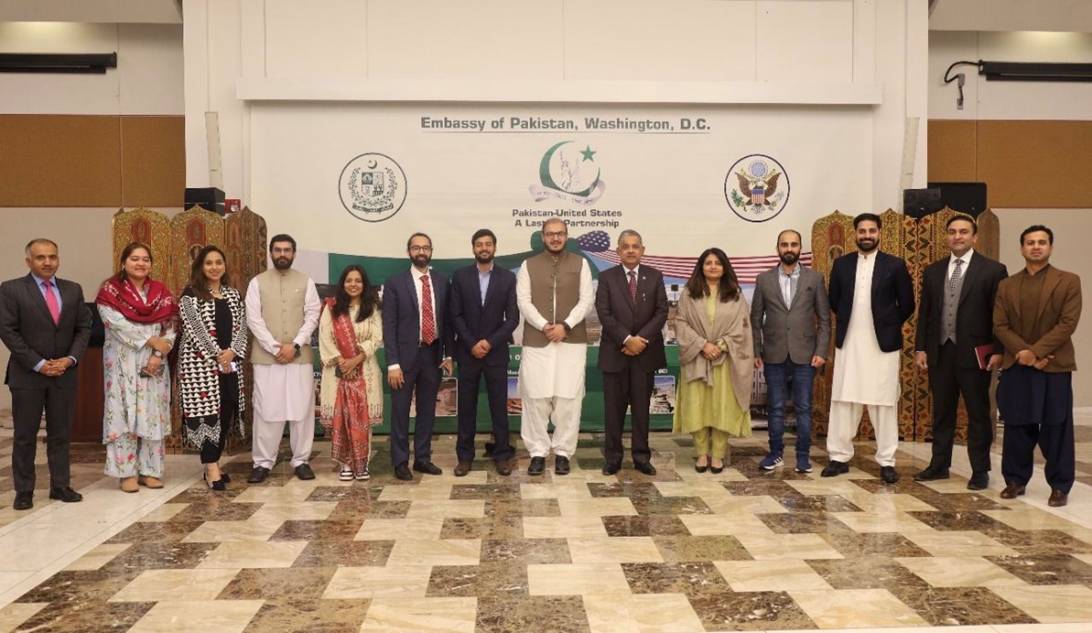 A group of people standing in front of a flag  AI-generated content may be incorrect.