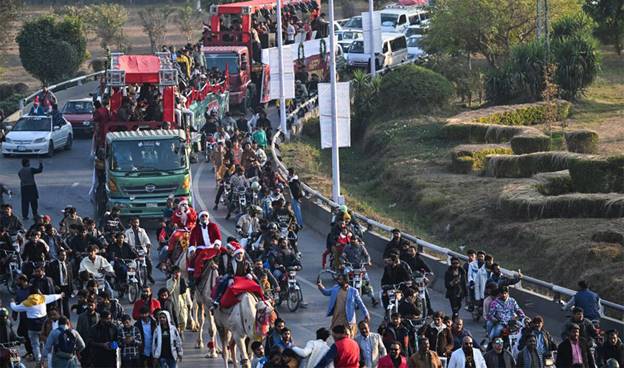 A group of people riding horses on a road  AI-generated content may be incorrect.