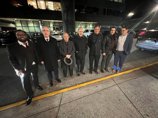 A group of men standing on the side of a road  AI-generated content may be incorrect.