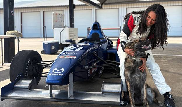 A person in a race car with a dog  AI-generated content may be incorrect.