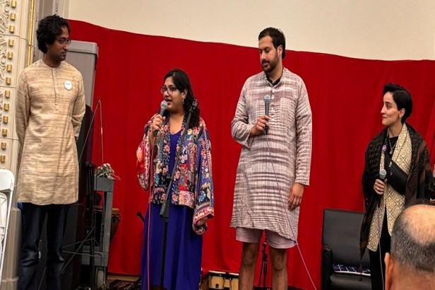 A person and person standing on a stage with microphones  AI-generated content may be incorrect.