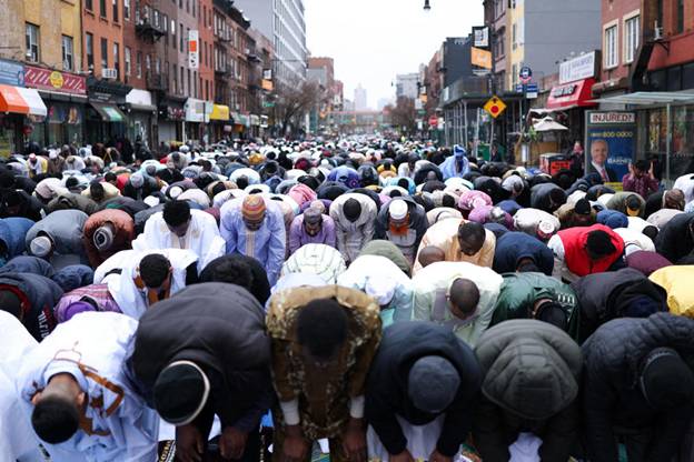 Members of the Muslim community attend prayers outside the Masjid-At-Taqwa Mosque during Eid al-Fitr celebrations in the Brooklyn borough of New York City on March 30, 2025.