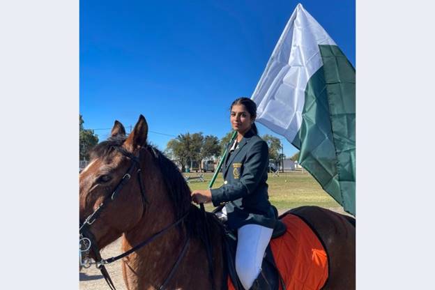 Ayesha Khan proudly holding Pakistan&rsquo;s flag in South Africa at the Under-21 World Tent Pegging Championship 2023, the only girl in a team of four boys