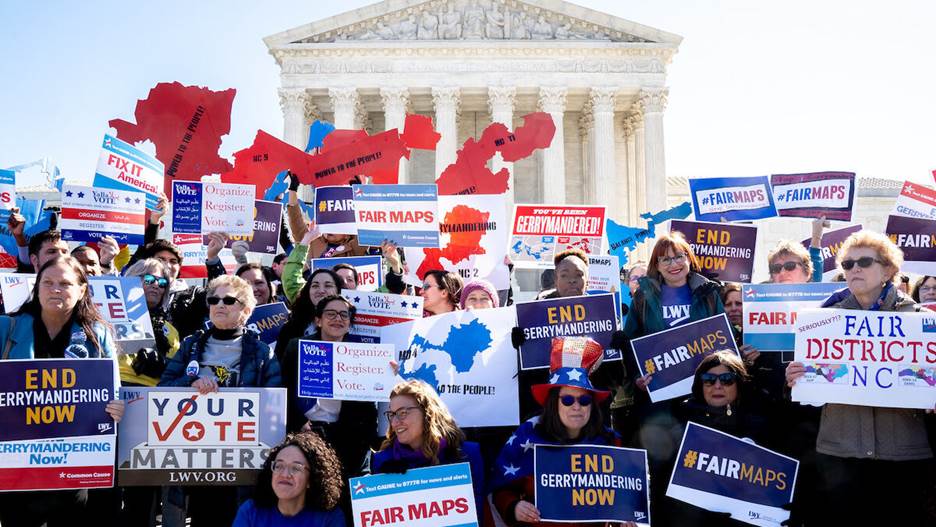 A group of people holding signs Description automatically generated