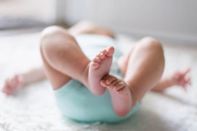 A close-up of a baby's feet Description automatically generated