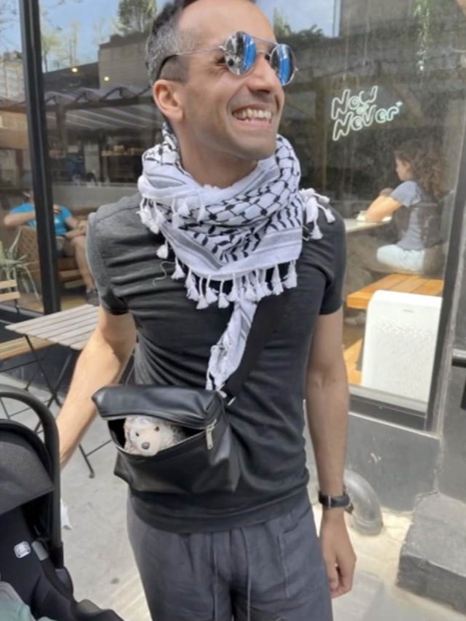 A person wearing a scarf and sunglasses Description automatically generated