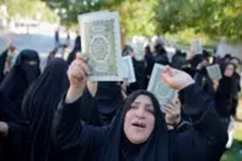 Iraqis raise copies of the Quran, Muslims' holy book, during a protest in Baghdad, Iraq, Saturday, July 22, 2023. Hundreds of protesters have attempted to storm Baghdad&rsquo;s heavily fortified Green Zone, which houses foreign embassies and the seat of Iraq&rsquo;s government, following reports of the burning of a Quran by a ultranationalist group in front of the Iraqi Embassy in Copenhagen. (AP Photo/Hadi Mizban)
