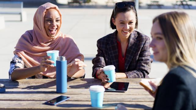 A group of people sitting at a table Description automatically generated with medium confidence
