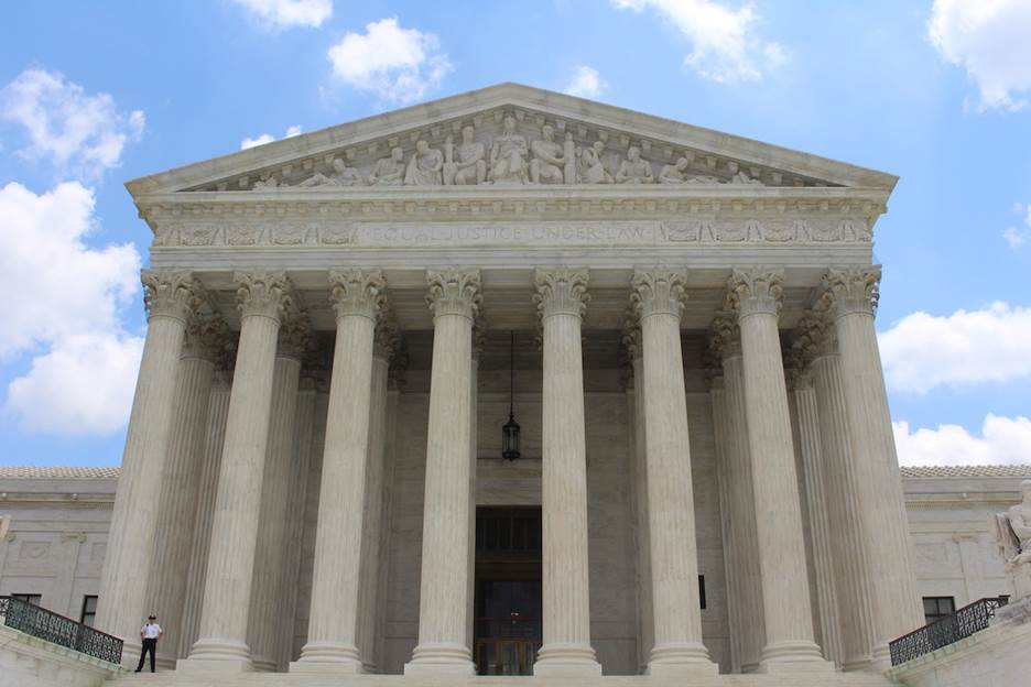 A low angle view of United States Supreme Court Building Description automatically generated with low confidence