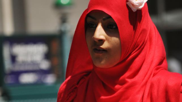 A person wearing a red head scarf Description automatically generated