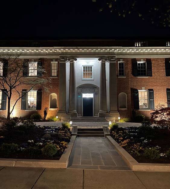 A building with a stone walkway leading to the front Description automatically generated
