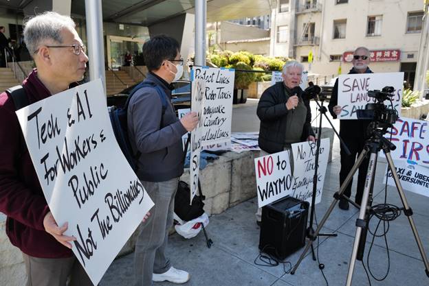 A group of people holding signs Description automatically generated