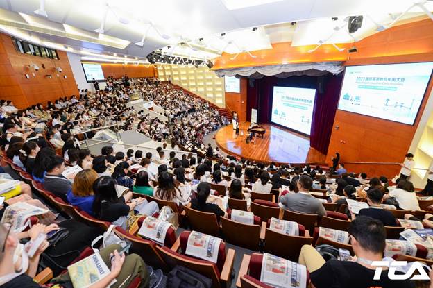 A group of people in a lecture hall Description automatically generated