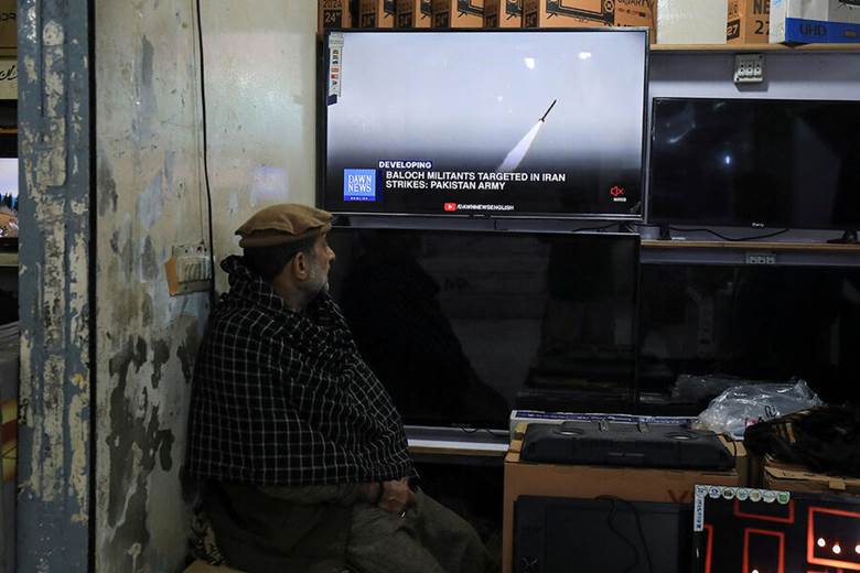 A person sitting in front of a television Description automatically generated