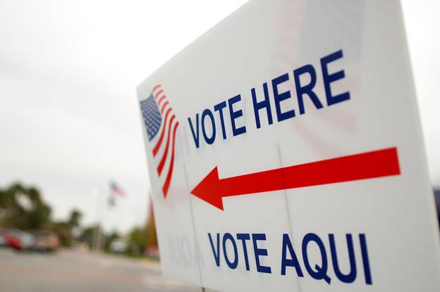 Close-up of a vote sign Description automatically generated