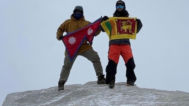 A couple of people holding flags on a snowy hill  AI-generated content may be incorrect.